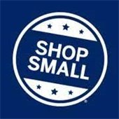 White circle in a dark blue square with SHOP SMALL in white letters in the center