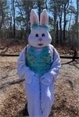 Person in a white Easter Bunny suit wearing a light green vest