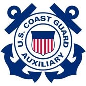 Crossed blue anchors with a red white and blue shield in the center with US Coast Guard Auxiliary in a white circle around the shield