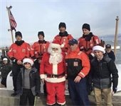 Santa surrounded by members of the US Coast Guard at the Chatham Fish Pier
