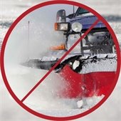 A truck plowing snow in a red circle with a slash through it