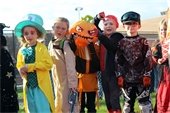 Elementary School age children in Halloween costumes