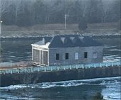 Shingled structure on a barge in a canal