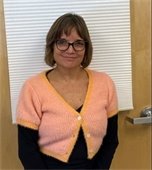 Woman wearing glasses standing in front of a door