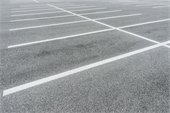 Asphalt parking lot with white painted lines