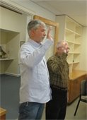 Cory Metters and Dean Nicastro with right hands raised being sworn in as Select Board members 