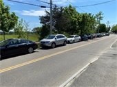 a row of cars parked along the side of a road