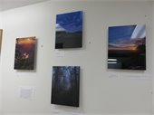 Four photographs arranged on a white wall.