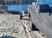 Chatham Shellfish Division pickup truck and trailer at Oyster Pond beach
