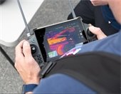 Fire Fighter looking at a radio control device screen