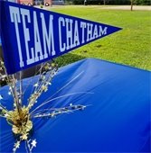 Blue pennant with Team Chatham on it on a table