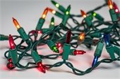 A tangle of multicolored holiday lights with one red bulb not working