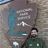 Dan Zoto standing in front of a National Park Service sign