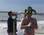 Fire Chief Justin Tavano in a jester hat on the beach