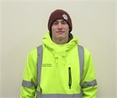 Young man in high visibility sweatshirt and beanie hat