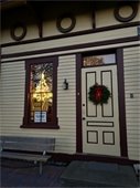 Green wreath on Railroad Museum's door and holiday lights in the window.