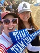 Candace Cook and Jill Goldsmith holding blue pennants with Team Chatham in white letters