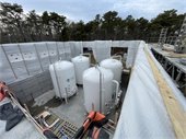 Large white tanks placed in a concrete structure