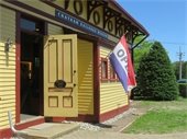 Chatham Railroad Museum with front door open and "Open" flag next to door.