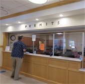 Permit counter with a man purchasing a permit