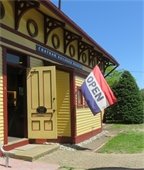 Chatham Railroad Museum with open door and flag saying open flying next to it.