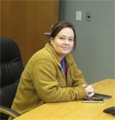 Recovery Coach Kelly Connelly seated at a conference table