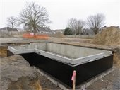 Poured concrete foundation of the Eldredge Garage Visitor Center under construction.
