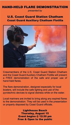 Coast Guard member holding a flare over the water