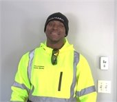 Odaine Powell wearing high visibility gear smiling at the camera