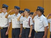 Junior Coast Guard ROTC cadets saluting