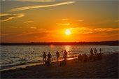 People on a beach at sunset