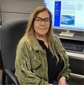 Christine Brantley sitting in a chair in front of a computer screen
