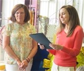 Town Manager Jill Goldsmith reads a proclamation as Michele Clarke looks on