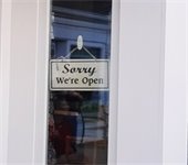 Sign in a window that reads "Sorry, we're open."